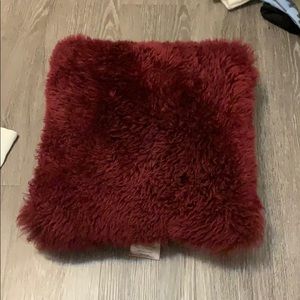 Maroon fuzzy decorative pillow
